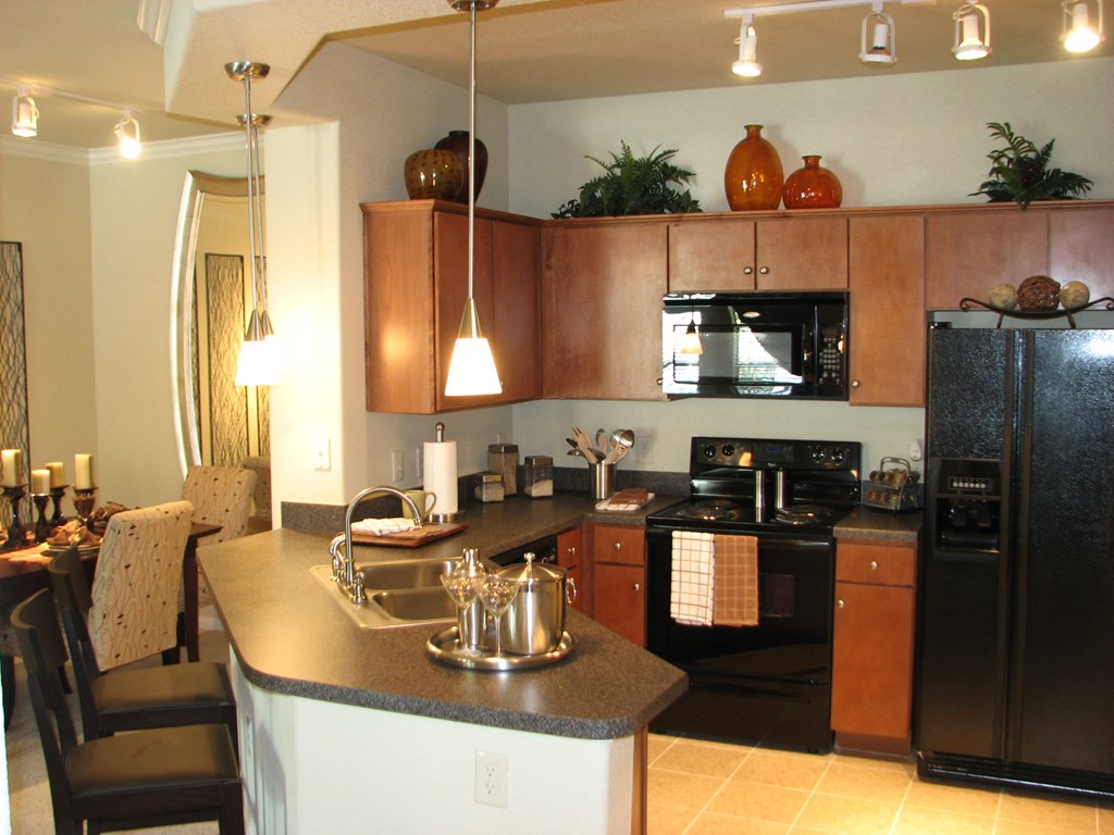a kitchen with a island and a table with chairs