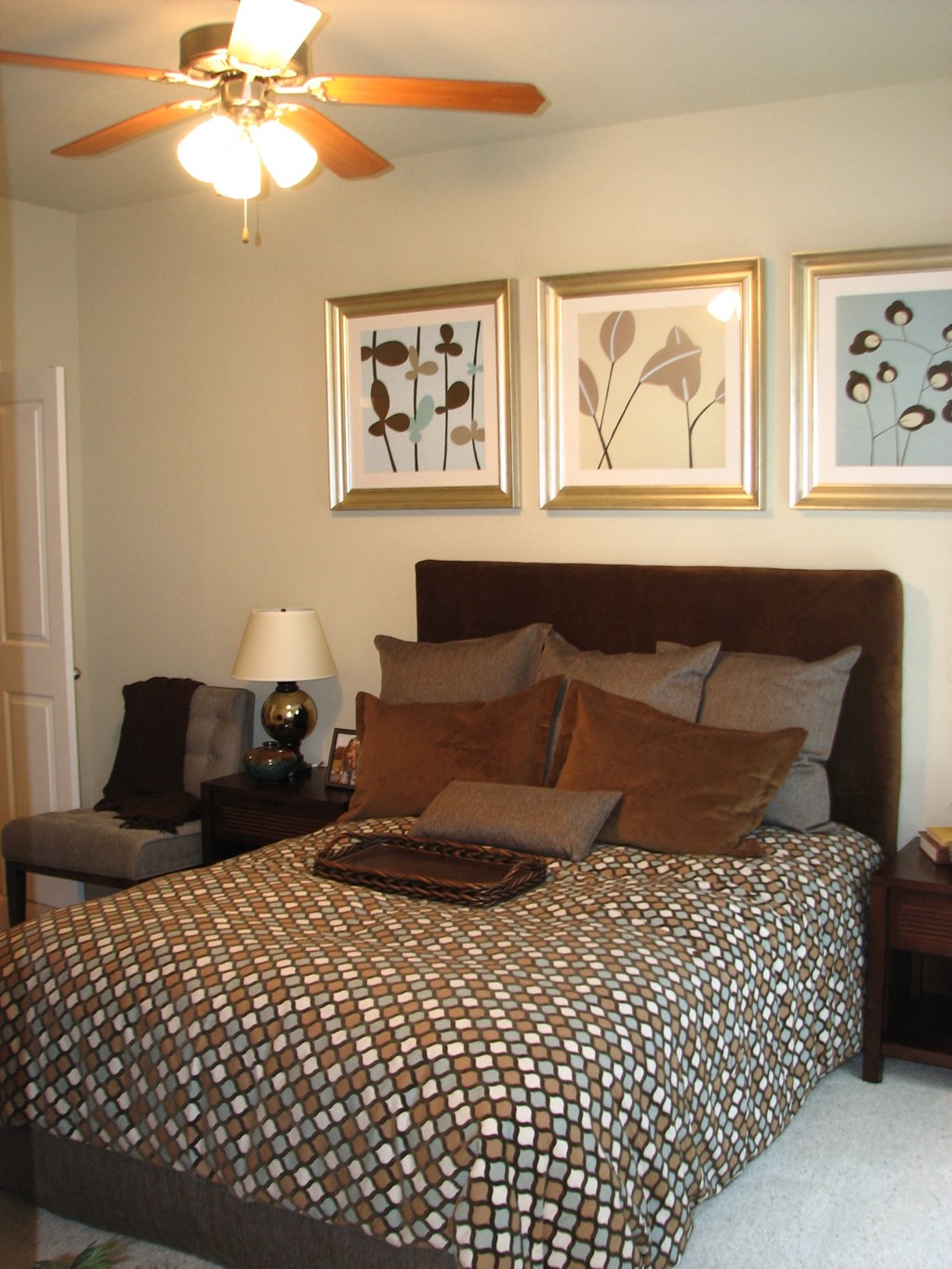 a bedroom with a bed and pictures on the wall