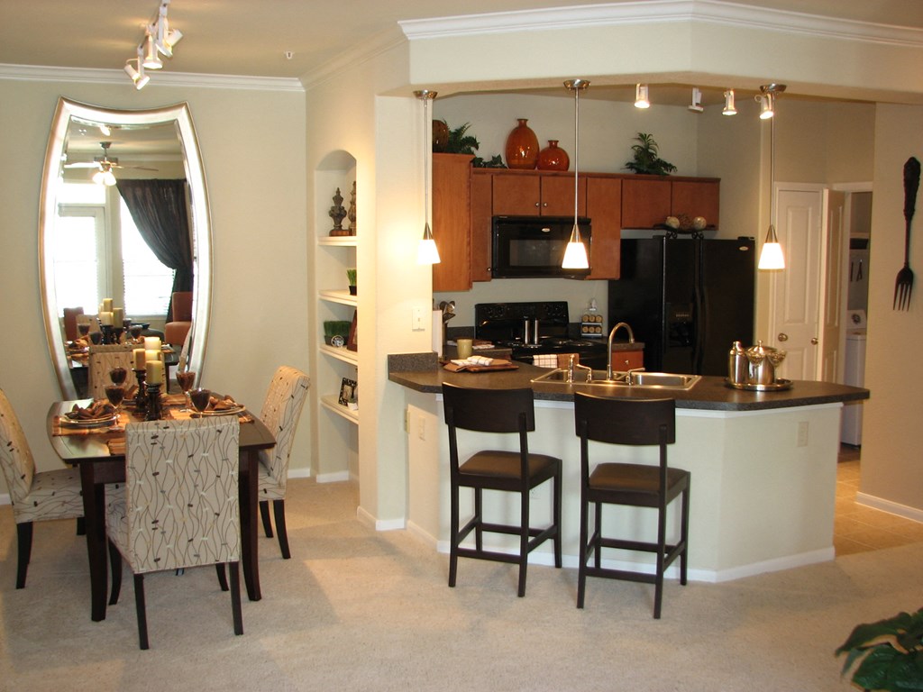 a kitchen and dining room with a table and chairs