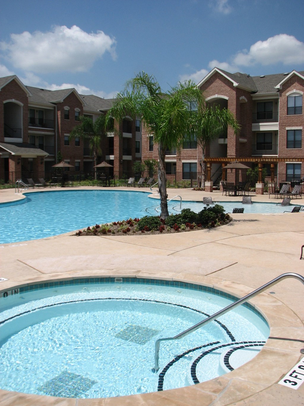 a swimming pool with an apartment building in the background