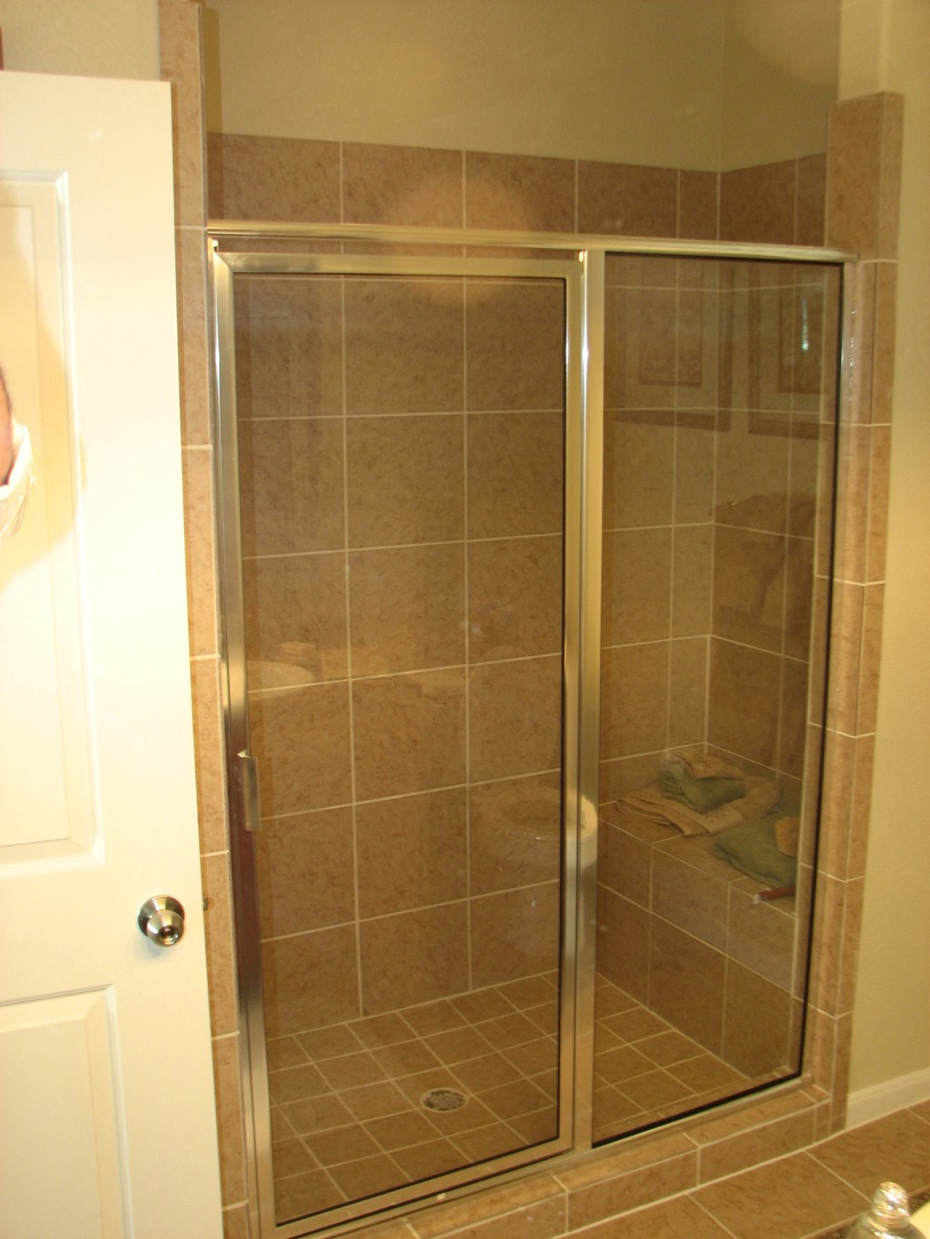 a shower in a bathroom with a glass door