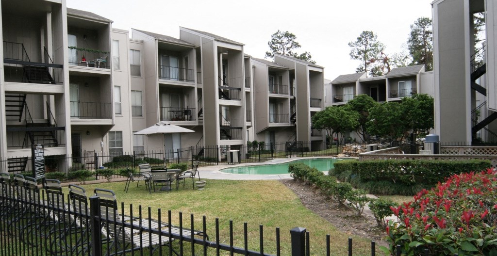 an apartment building with a pool and a courtyard