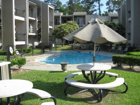 a swimming pool with a table and an umbrella