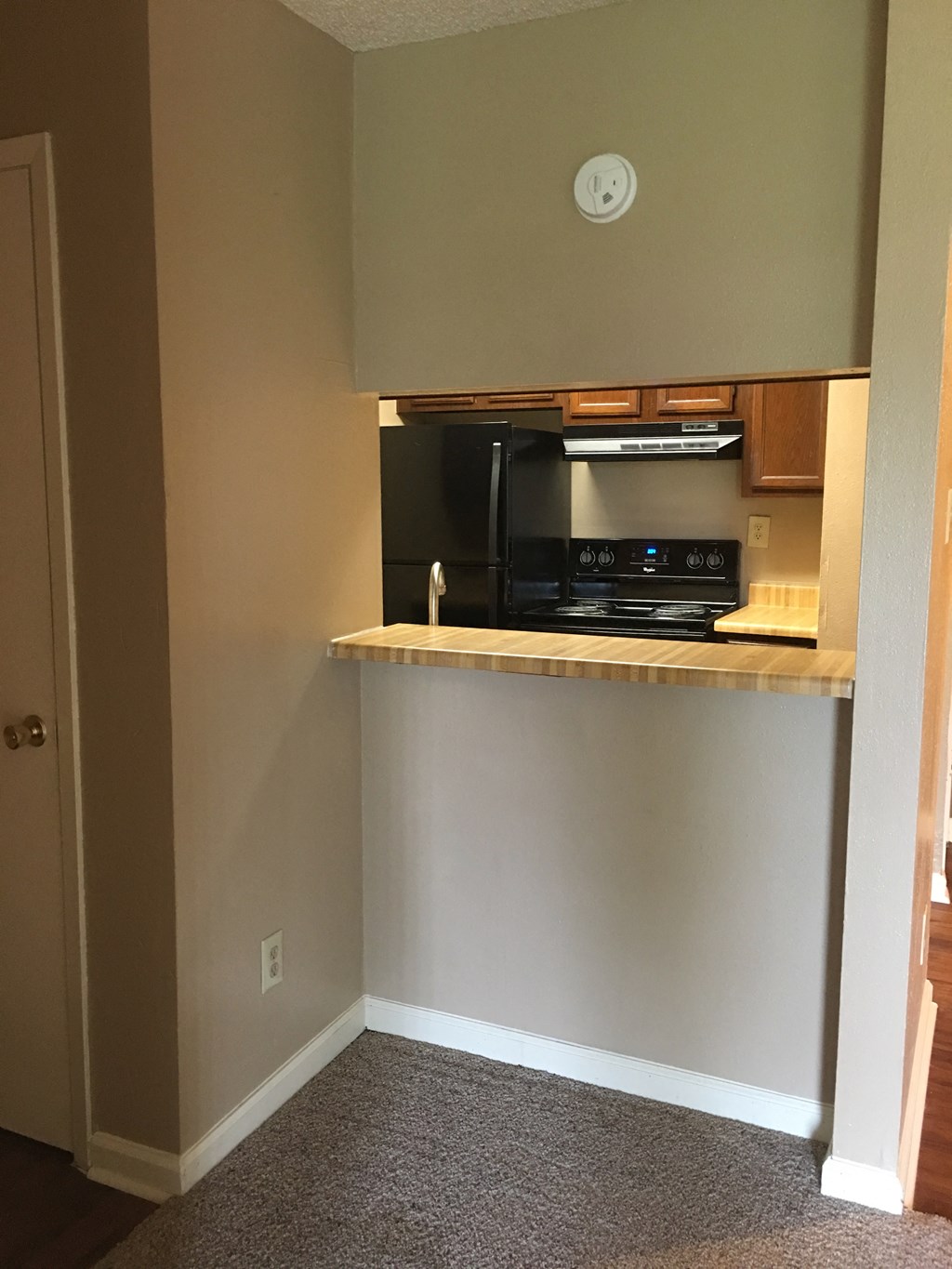 a kitchen with a counter and a microwave in it