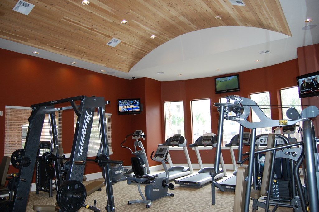 a gym with treadmills and other exercise equipment