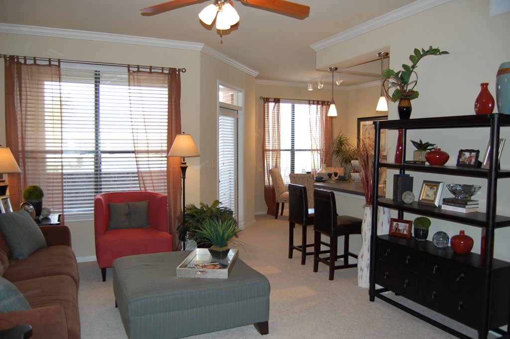a living room with a couch and a chair and a dining room table