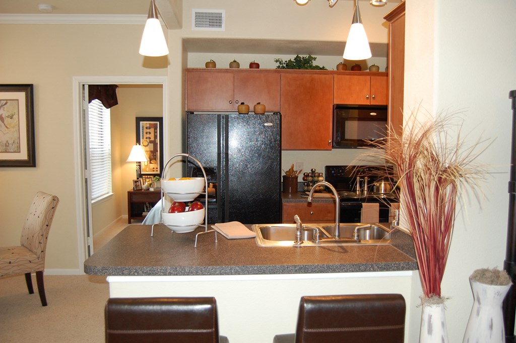 a kitchen with a counter top and a refrigerator