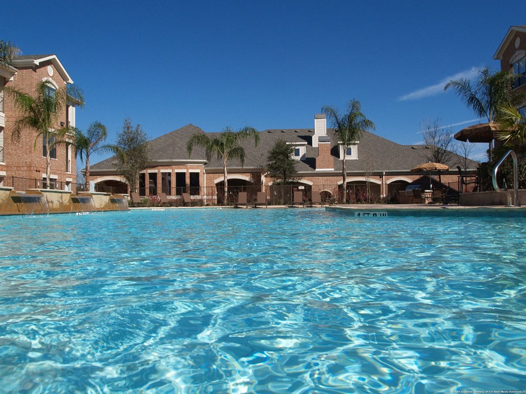 the view of a swimming pool with a large building in the background