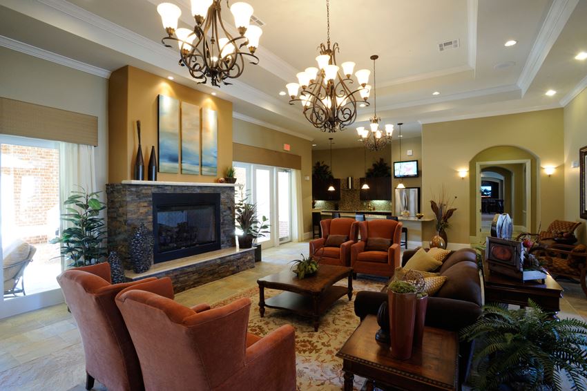 a living room with couches and chairs and a fireplace