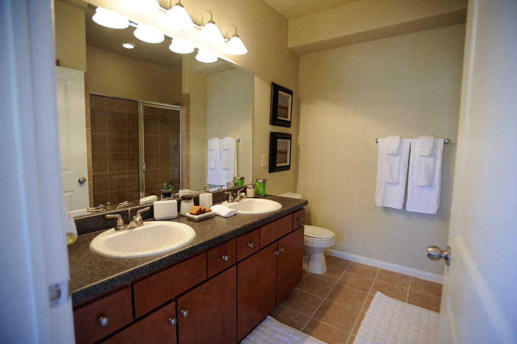 a bathroom with two sinks and a toilet
