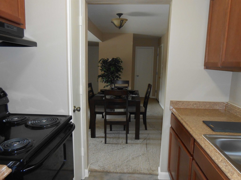 an empty kitchen and dining room with a table and chairs
