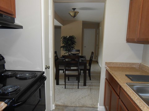 an empty kitchen and dining room with a table and chairs