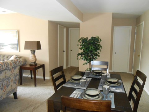a dining room and living room with a table and chairs
