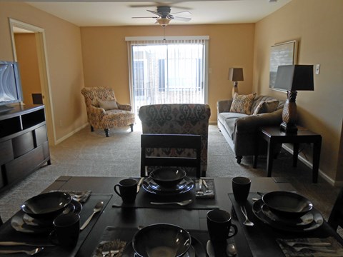 a view of the living room from behind the dining room table