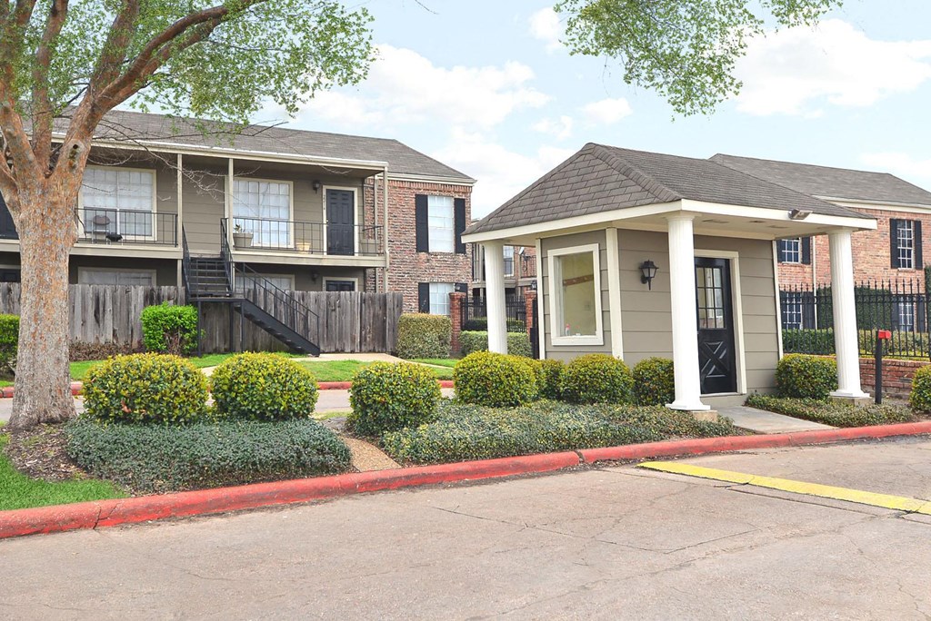 a street view of an apartment building with a driveway
