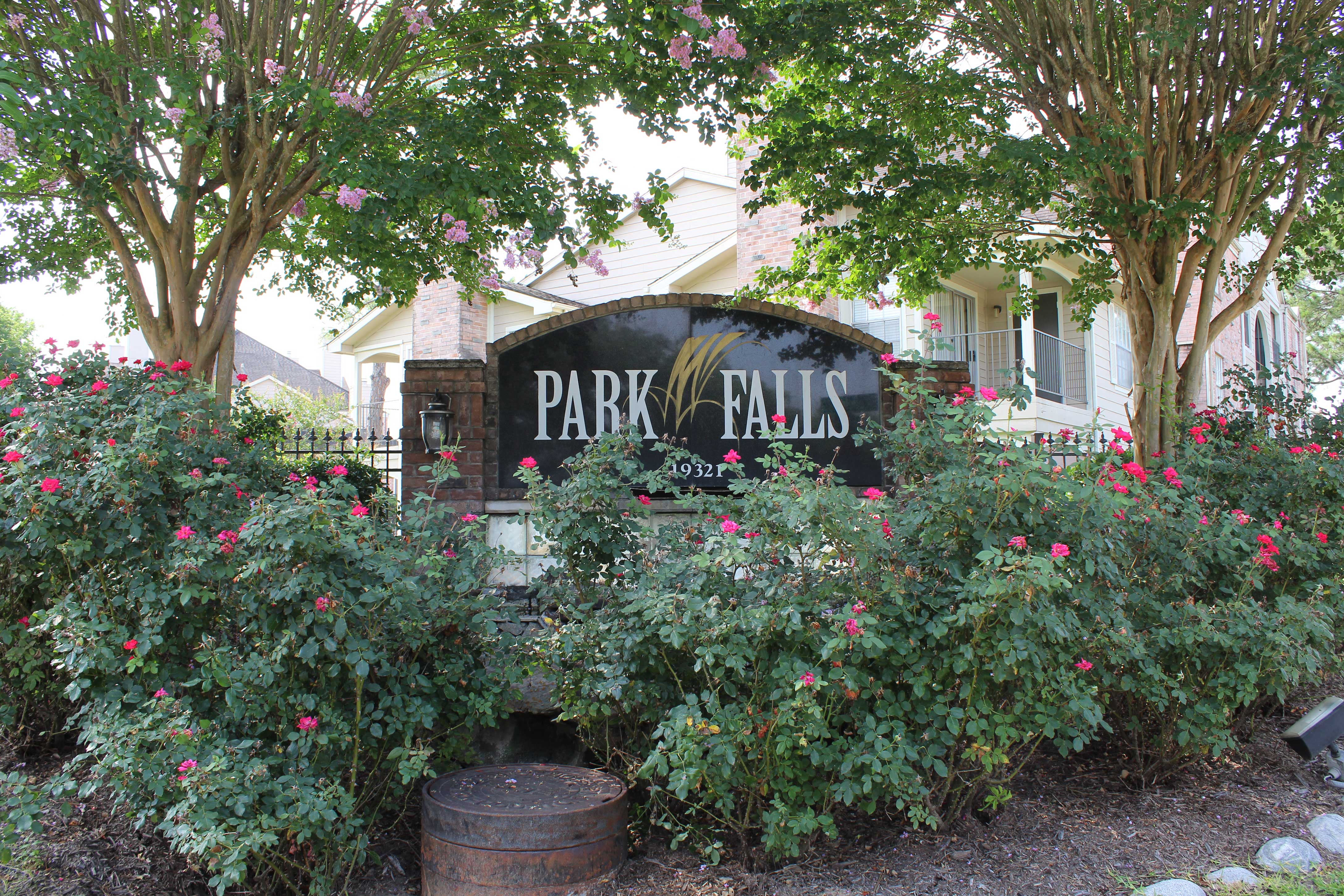 a sign for park falls in front of a house