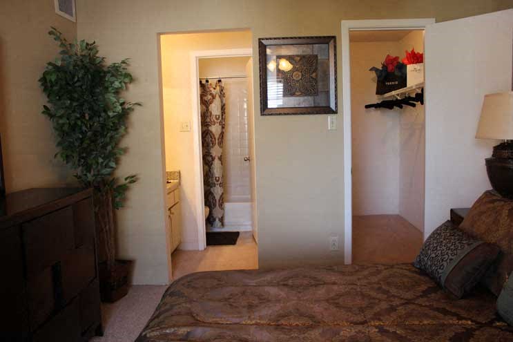 a bedroom with a bed and a door to a bathroom