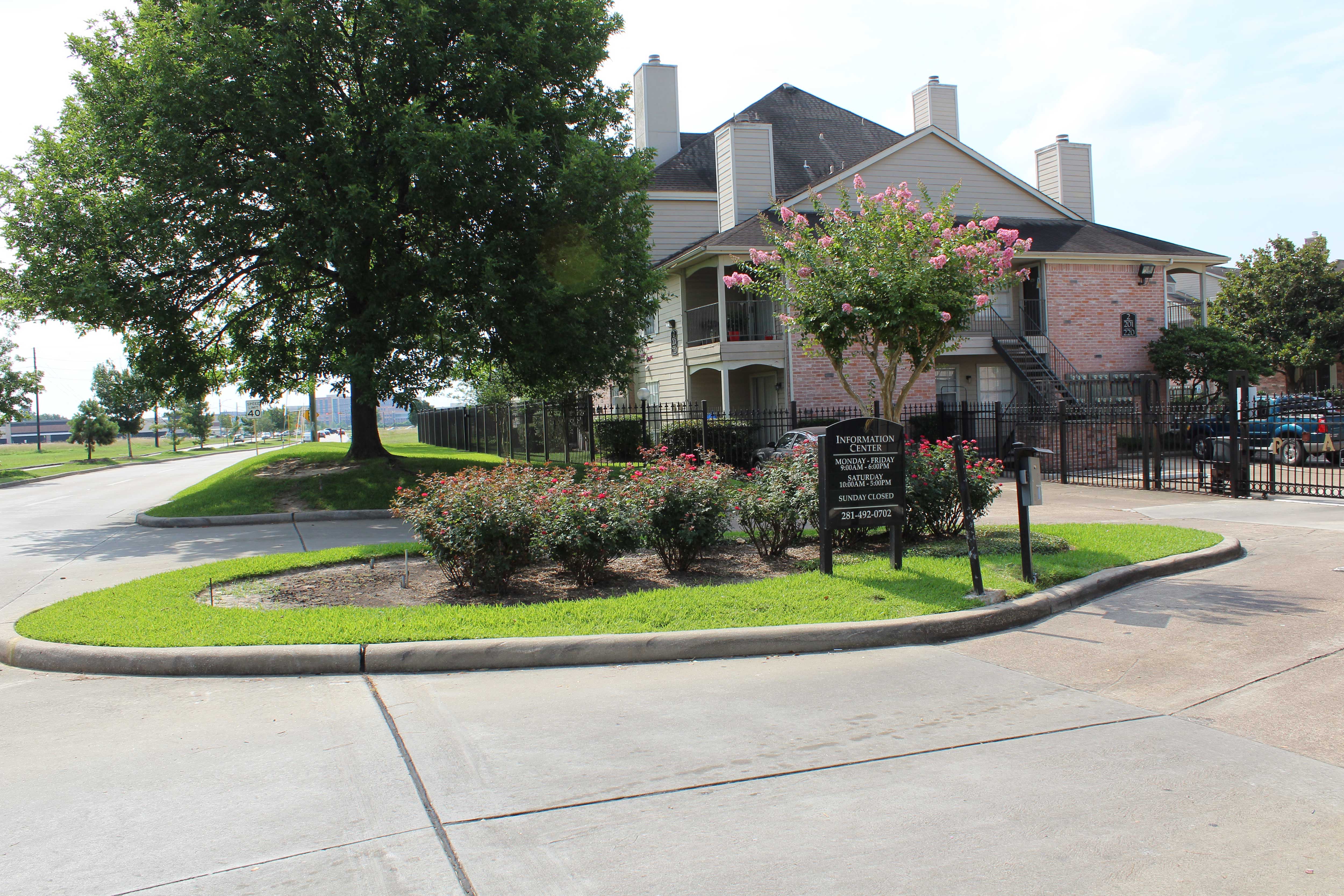a roundabout in front of a house with a sign