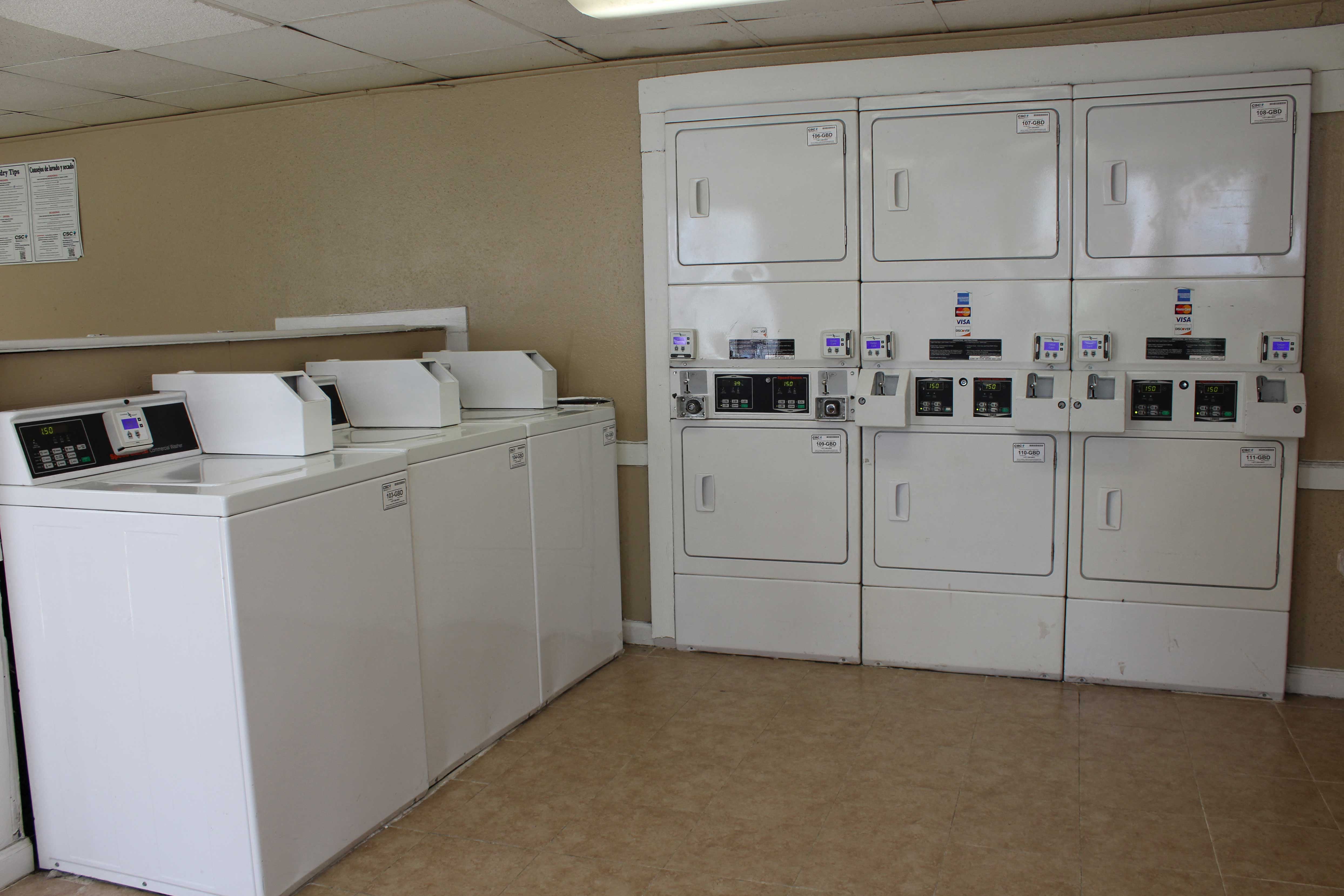 the laundry room is full of washers and dryers