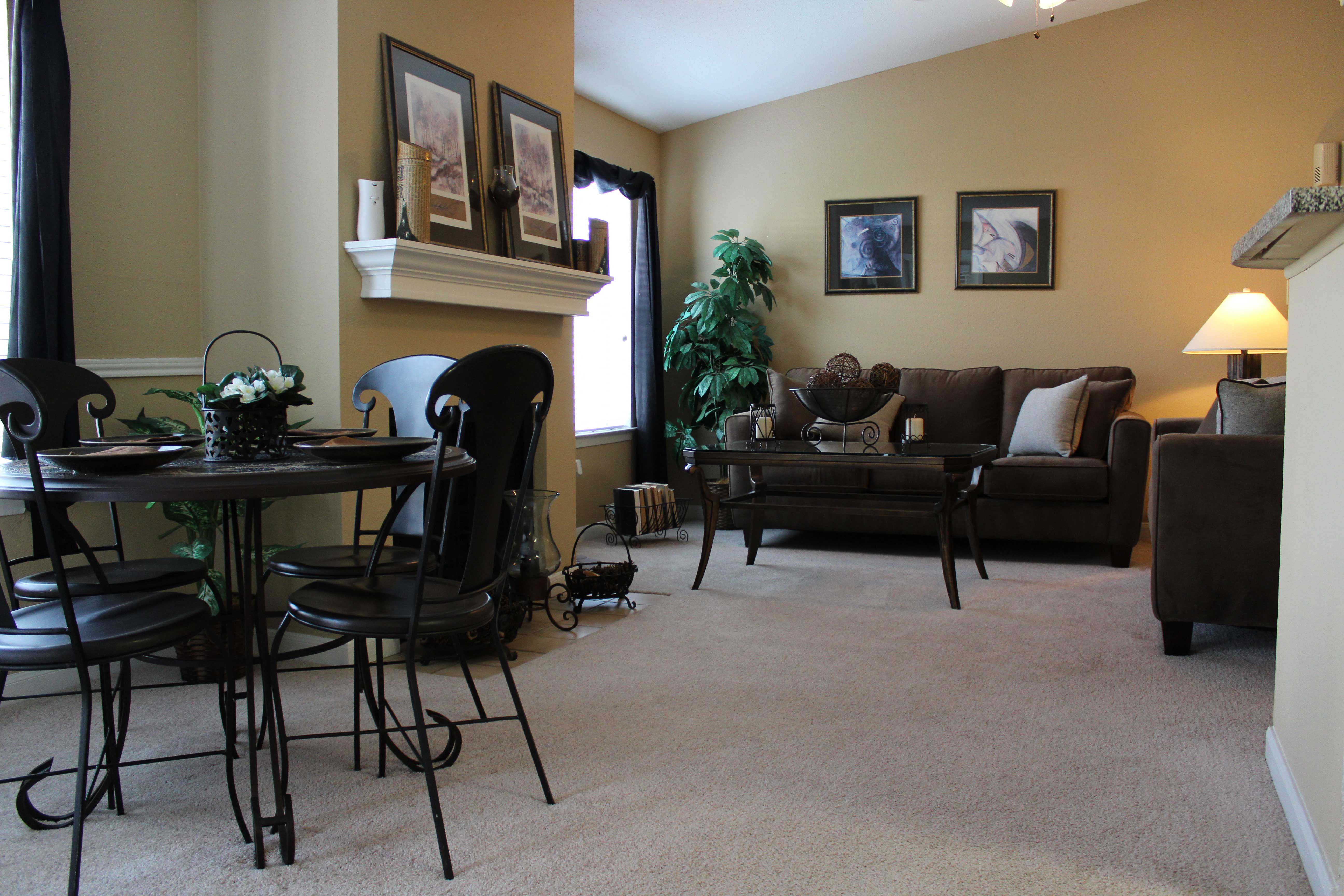 a living room with a table and chairs and a couch