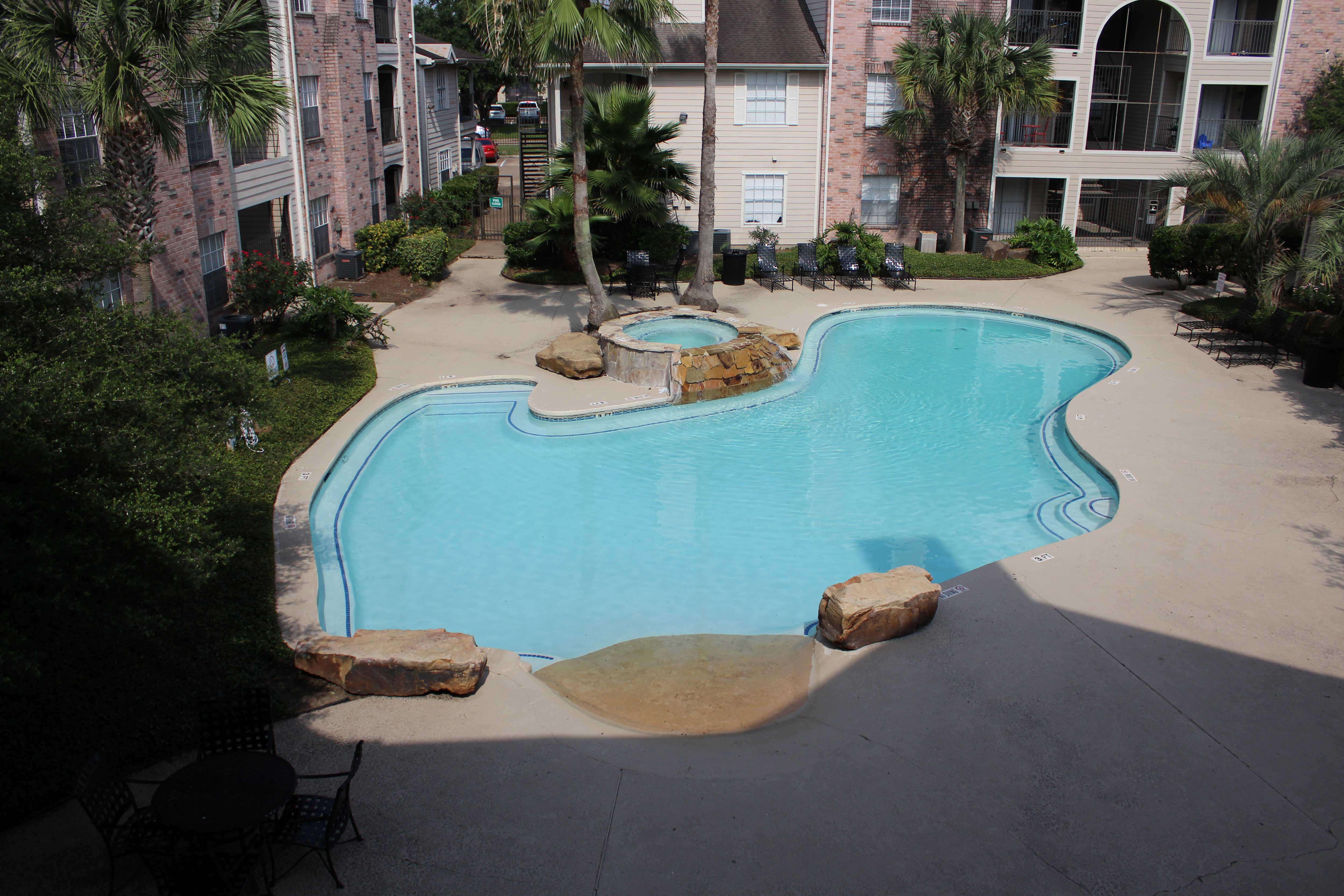 a large swimming pool with a building in the background