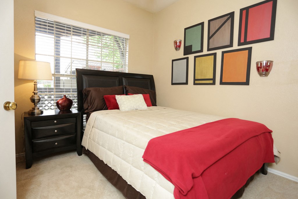 a bedroom with a bed and some pictures on the wall