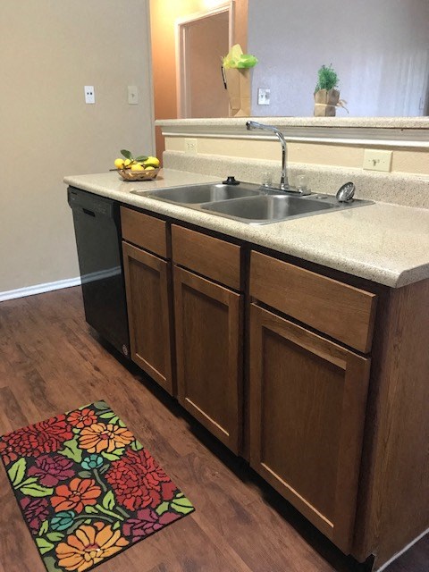 a kitchen with a sink and wooden cabinets