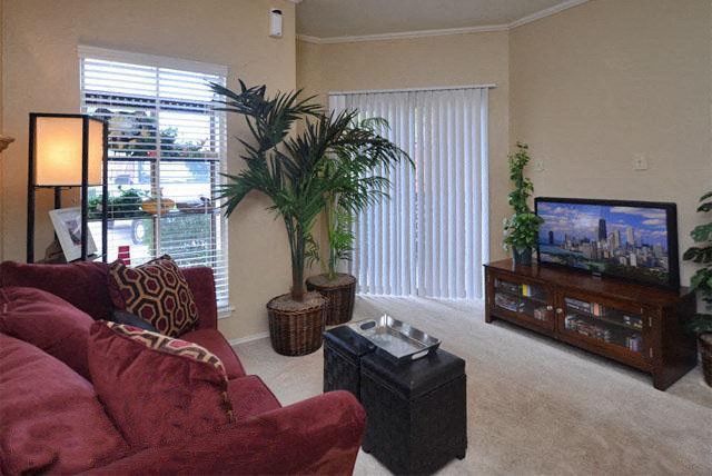 a living room with a red couch and a television