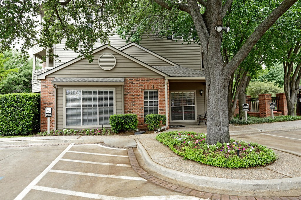 the front of a house with a tree in the yard