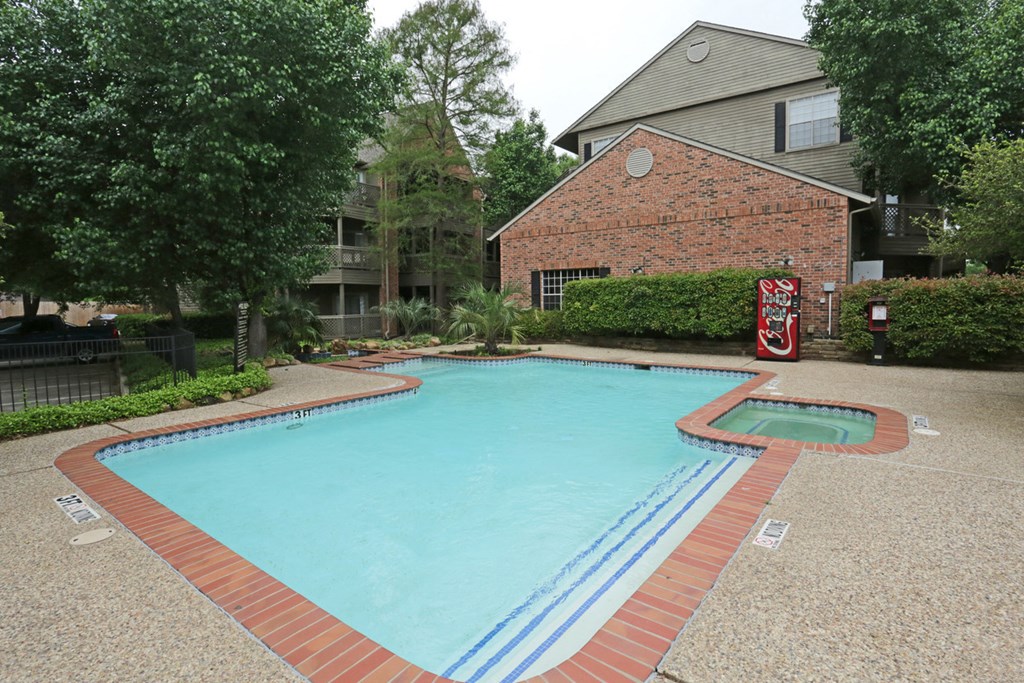 a swimming pool in front of an apartment building