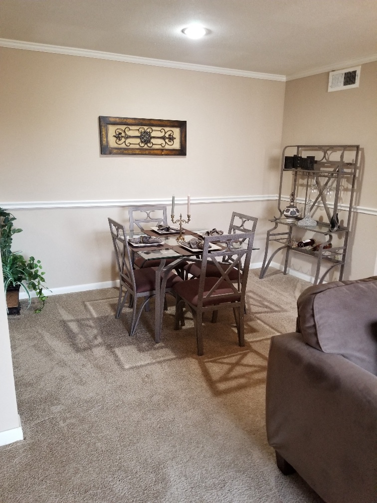 a dining room with a table and chairs and a couch