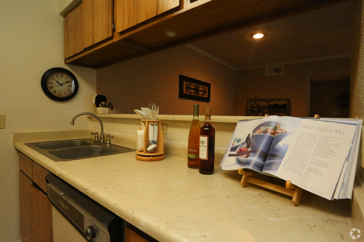 a kitchen with a sink and a magazine on the counter
