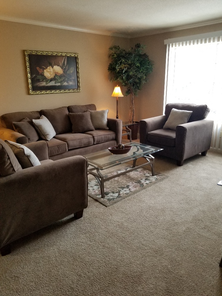 a living room with couches and chairs and a table
