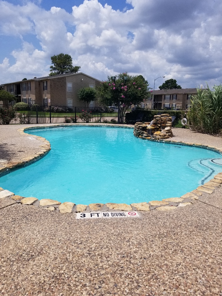 a swimming pool in front of an apartment building