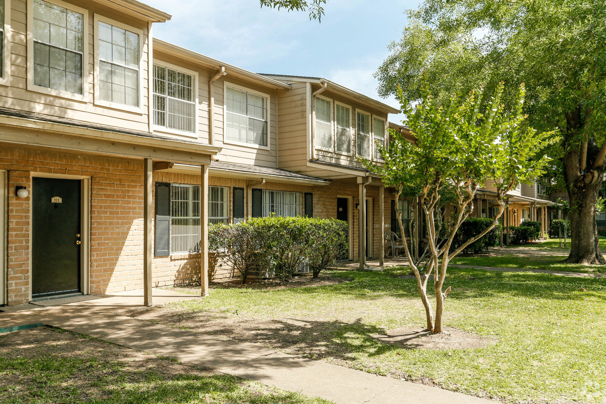 our apartments are located in a quiet neighborhood with trees and grass