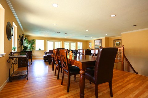 a large dining room with a wooden table and chairs