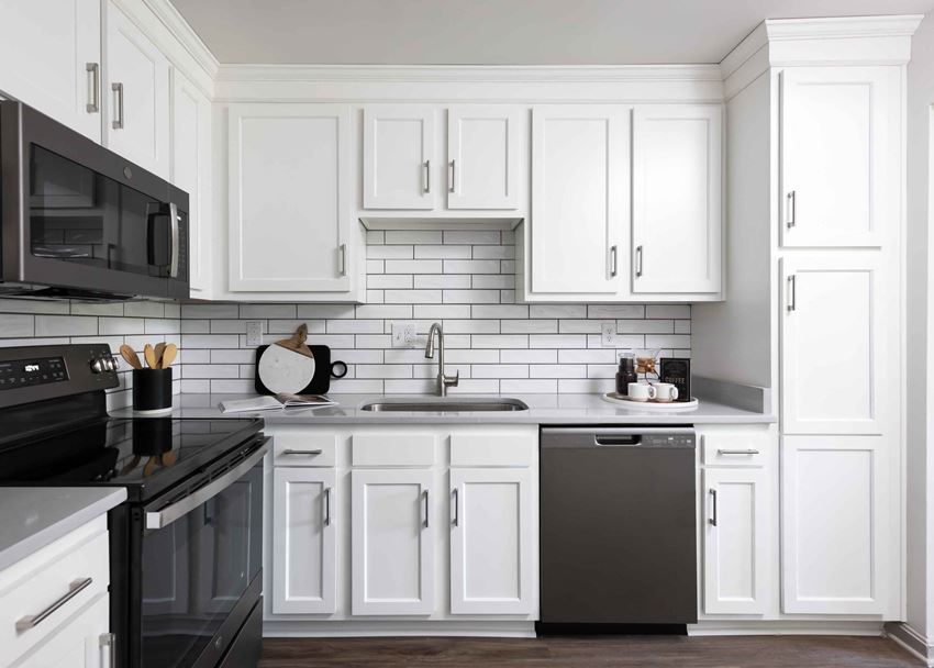 Hurstbourne Grand Apartments Louisville modern kitchen with slate appliances and white cabinetry - Photo Gallery 1