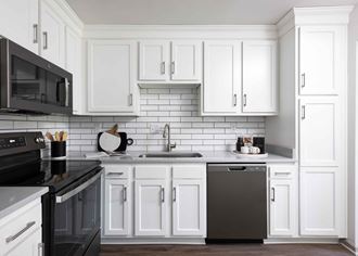 Hurstbourne Grand Apartments Louisville modern kitchen with slate appliances and white cabinetry