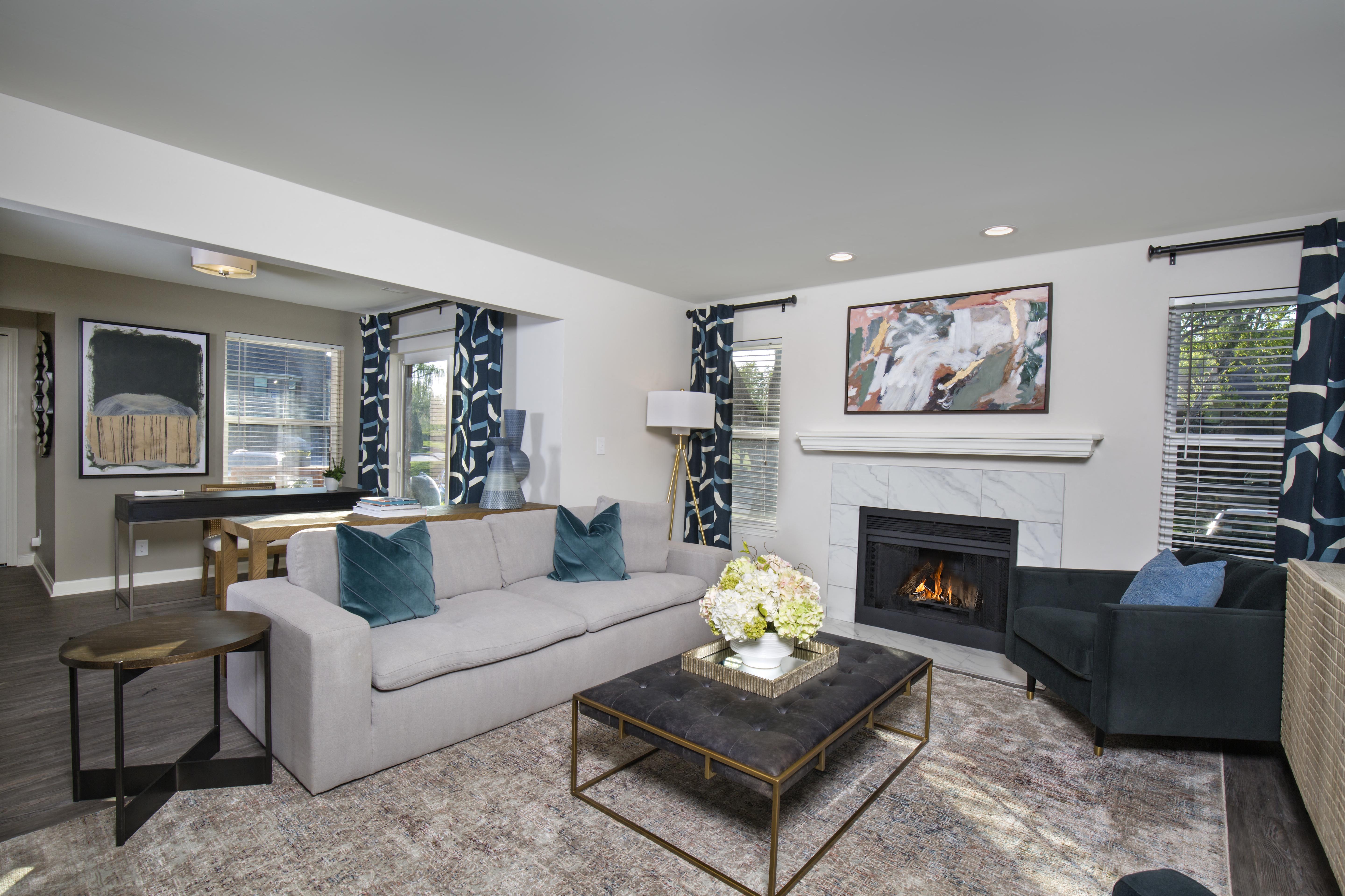a living room with a couch and a coffee table and a fireplace