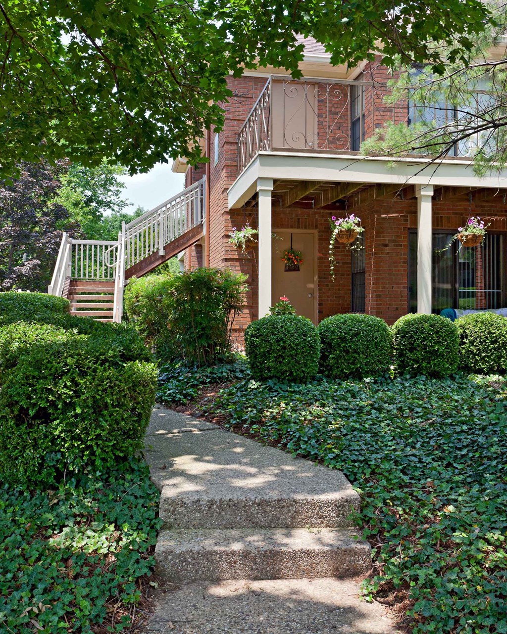 The Willows Apartments Louisville building entrance with lush greenery