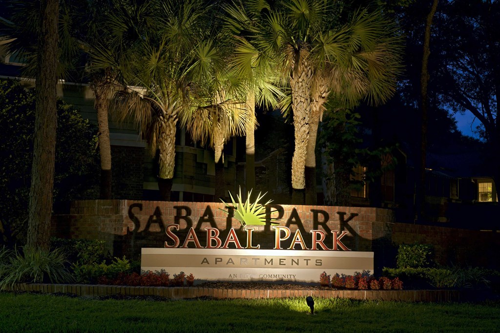 Longwood Sabal Park Apartments community entrance sign at dusk