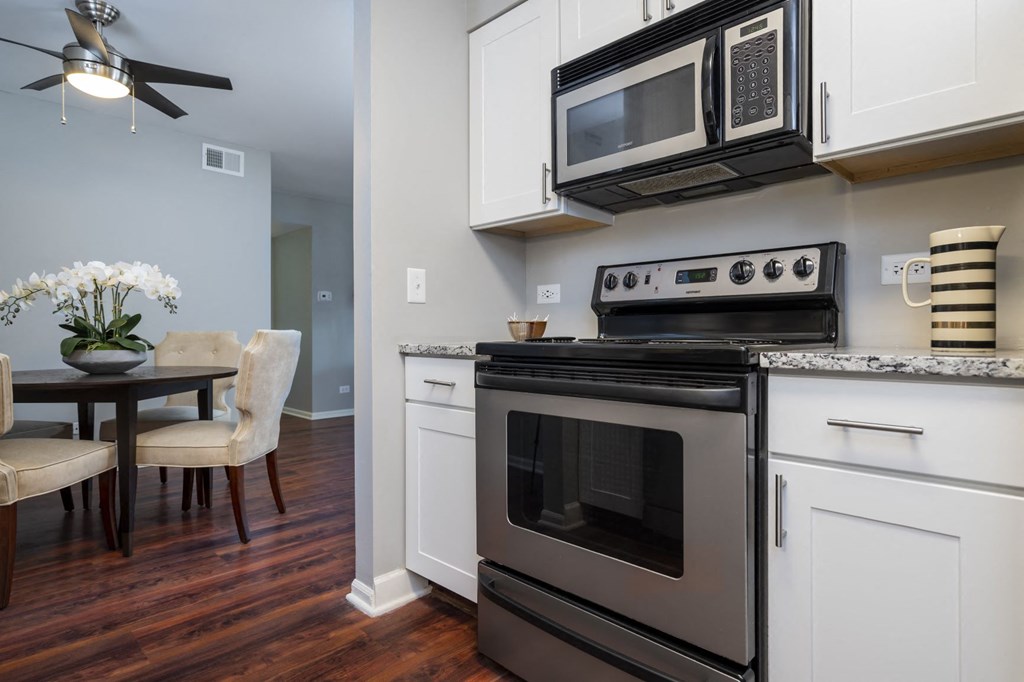 a kitchen with stainless steel appliances and a microwave