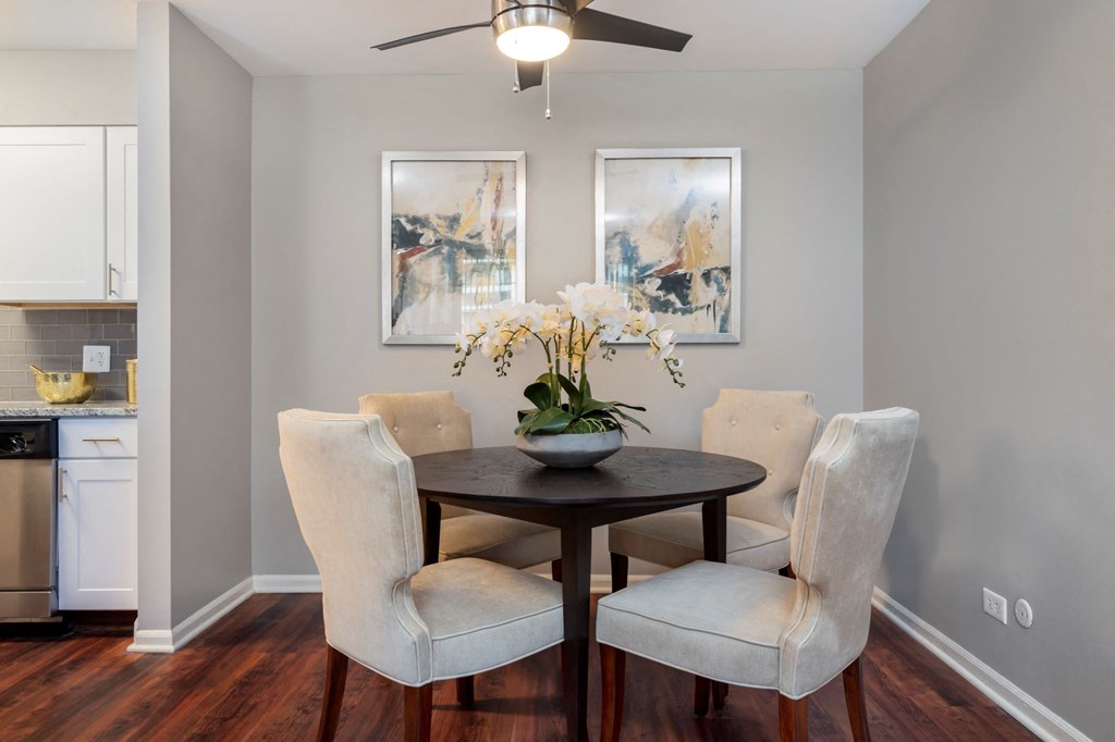 a dining room with a table and chairs