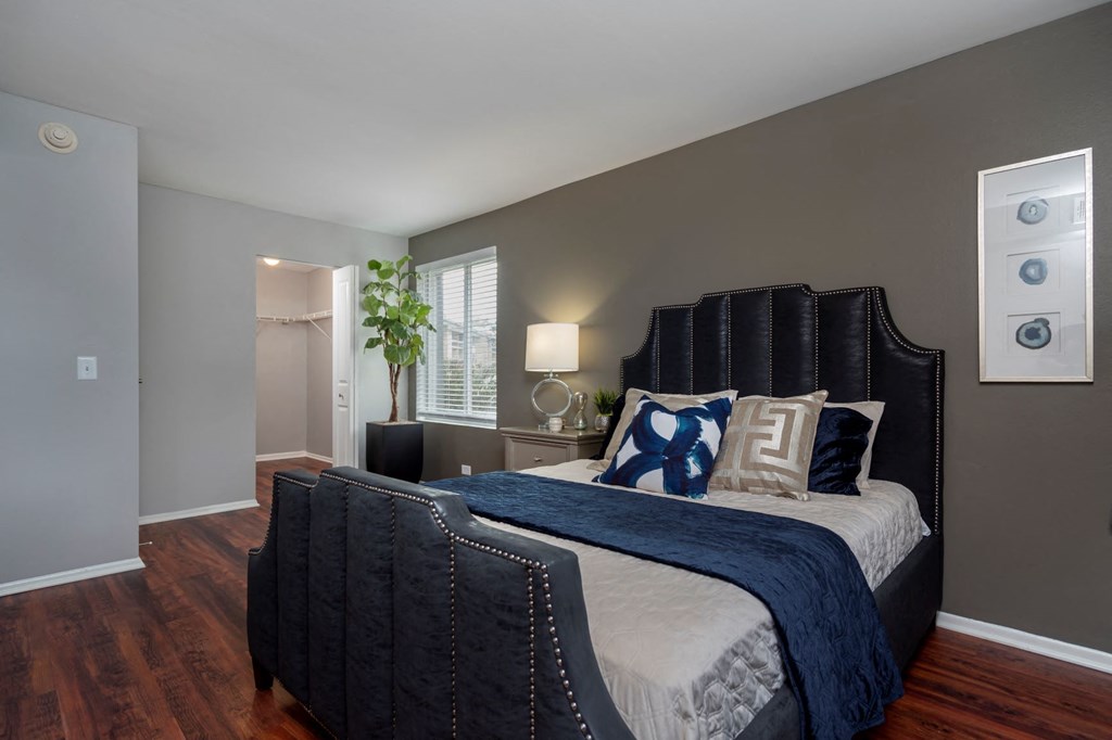 a bedroom with a large bed and a window