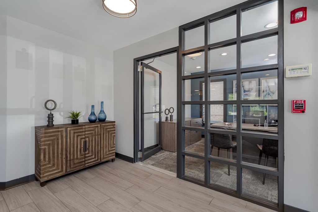 a conference room with glass doors and a table and chairs