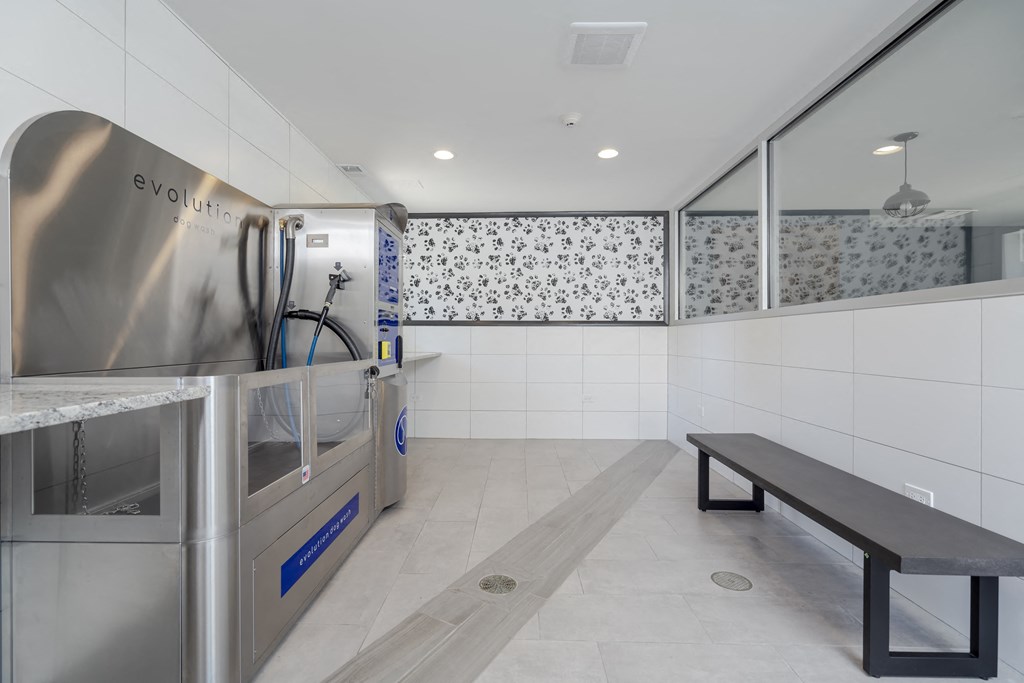 the kitchen has stainless steel appliances and a bench