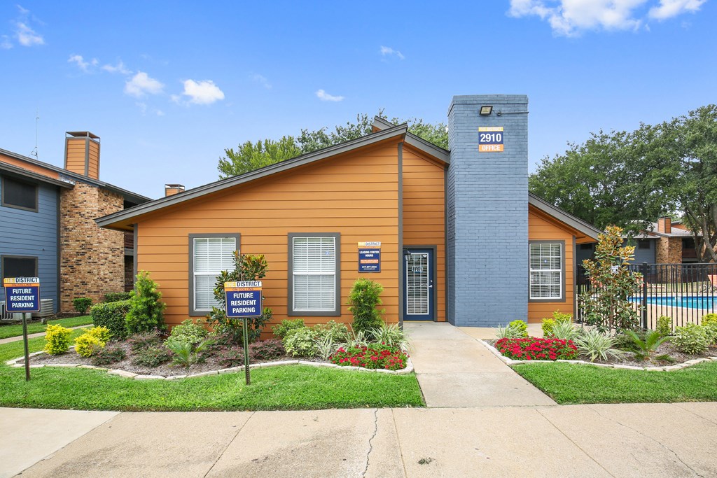 an orange building with a sidewalk in front of it