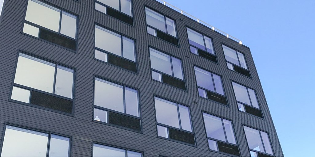 a large building with many windows and a blue sky