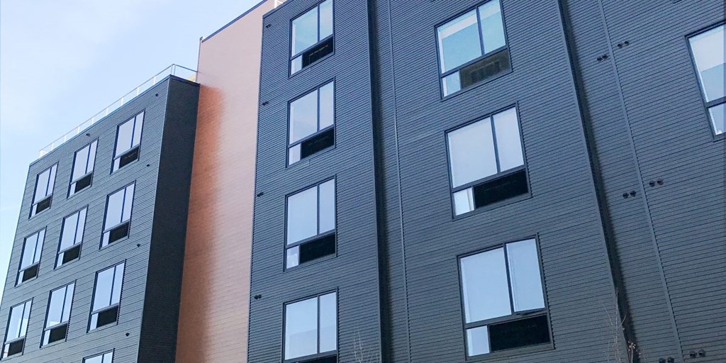 a large building with many windows and a brown wall