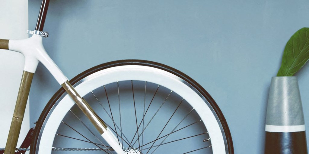 a bike wheel and a vase with a plant